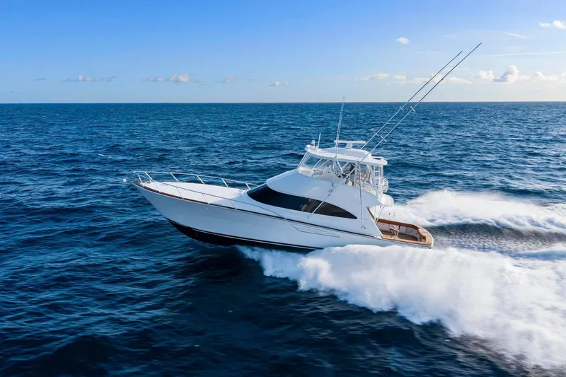 Slide: The Image of 2025 Viking 58 Convertible yacht cruising on open ocean under clear blue sky. - 5