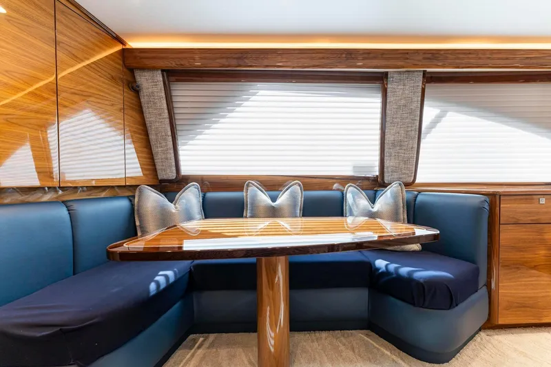 Slide: The Image of Luxurious interior of 2025 Viking 58 Convertible yacht with elegant seating and wooden table. - 50