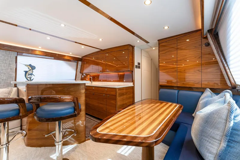 Slide: The Image of Luxurious interior of 2025 Viking 58 Convertible yacht with polished wood and modern seating. - 52