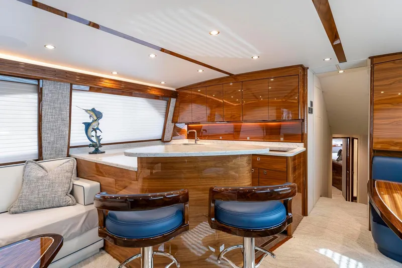 Slide: The Image of Luxurious interior of 2025 Viking 58 Convertible yacht with elegant wood finishes and modern design. - 53
