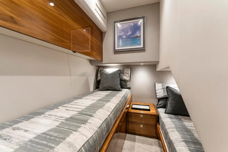 Slide: The Image of Luxurious cabin interior of 2025 Viking 58 Convertible yacht with twin beds and elegant decor. - 55