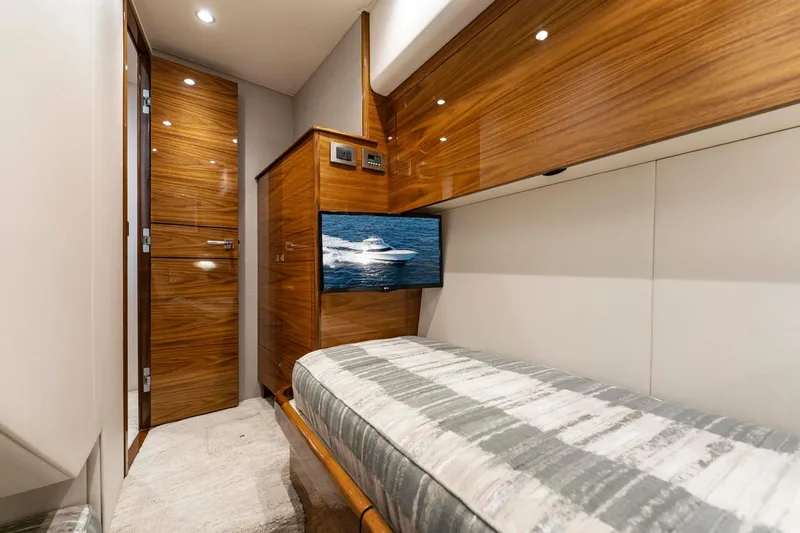 Slide: The Image of 2025 Viking 58 Convertible yacht interior with wood finish and modern amenities. - 57