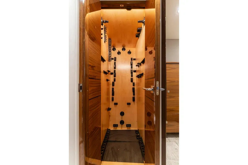 Slide: The Image of Interior of 2025 Viking 58 Convertible yacht, featuring a wooden storage compartment. - 59