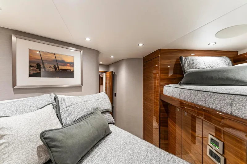 Slide: The Image of Luxurious cabin interior of 2025 Viking 58 Convertible yacht with elegant bedding and wood finishes. - 63