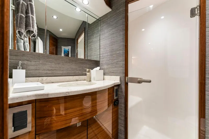 Slide: The Image of Luxurious bathroom in 2025 Viking 58 Convertible yacht with modern fixtures and elegant design. - 64