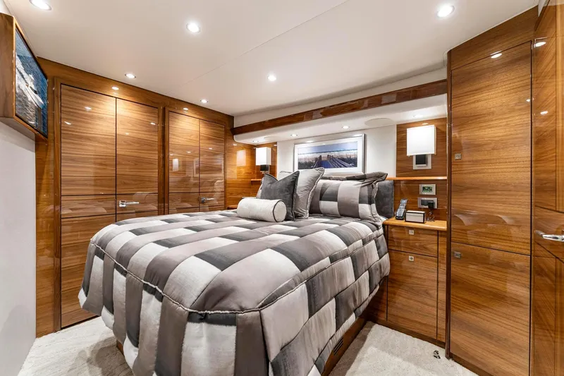 Slide: The Image of Luxurious bedroom interior of 2025 Viking 58 Convertible yacht with elegant wood finishes. - 65