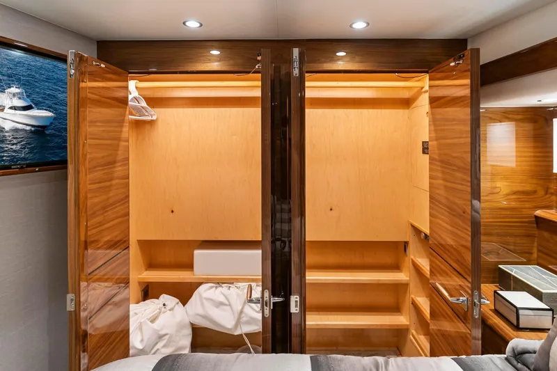 Slide: The Image of Luxurious wooden closets inside 2025 Viking 58 Convertible yacht cabin. - 67