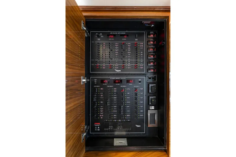 Slide: The Image of Electrical panel inside 2025 Viking 58 Convertible yacht, showcasing control switches and indicators. - 69