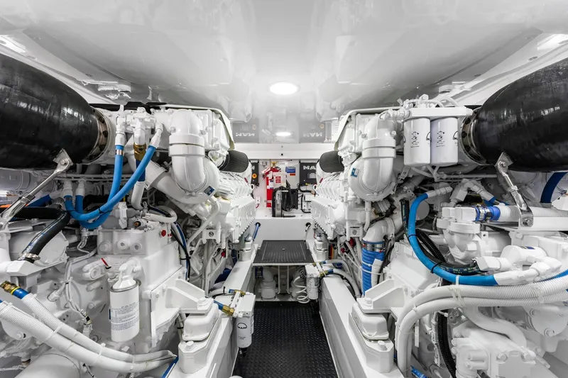 Slide: The Image of Engine room of 2025 Viking 58 Convertible yacht, showcasing advanced machinery and piping. - 73