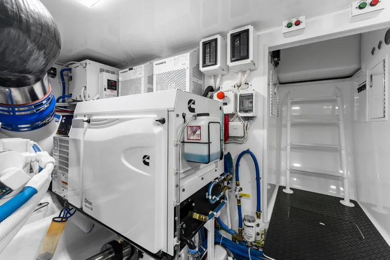 Slide: The Image of Engine room of 2025 Viking 58 Convertible yacht, featuring advanced equipment and controls. - 78