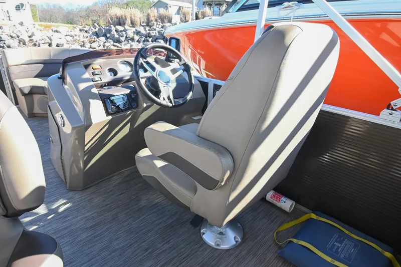 Slide: The Image of Interior of 2021 Bennington SX 23 Entertainment boat with steering wheel and seating. - 15