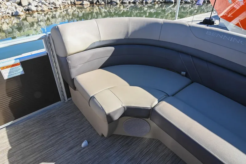 Slide: The Image of 2021 Bennington SX 23 Entertainment boat interior with plush seating and lake view. - 24