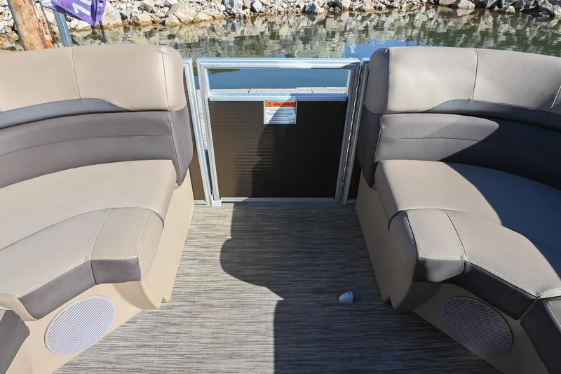 Slide: The Image of Interior seating of 2021 Bennington SX 23 Entertainment pontoon boat by the water. - 26