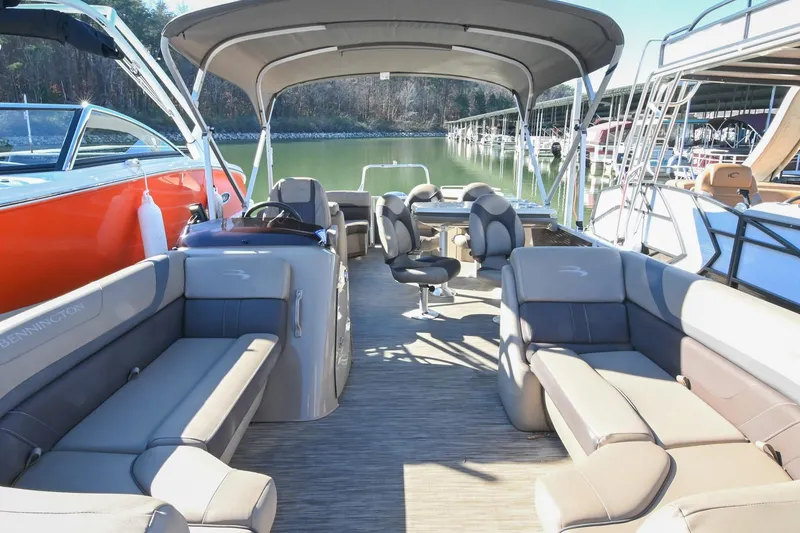 Slide: The Image of 2021 Bennington SX 23 Entertainment pontoon boat interior with seating and canopy. - 3