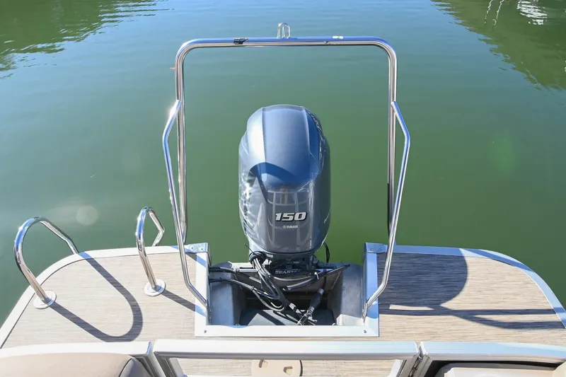 Slide: The Image of 2021 Bennington SX 23 Entertainment boat with Yamaha 150 outboard motor on calm water. - 5