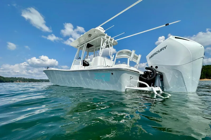 Slide: The Image of 2024 ZCB Freemason 26 Open boat on trailer, urban backdrop, clear sky. - 1