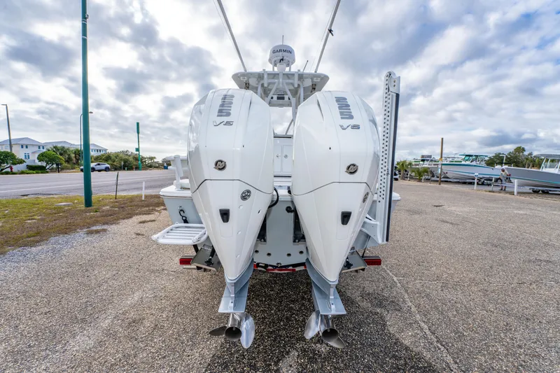 Slide: The Image of 2024 ZCB Freemason 26 Open boat with dual V6 engines, parked outdoors. - 13