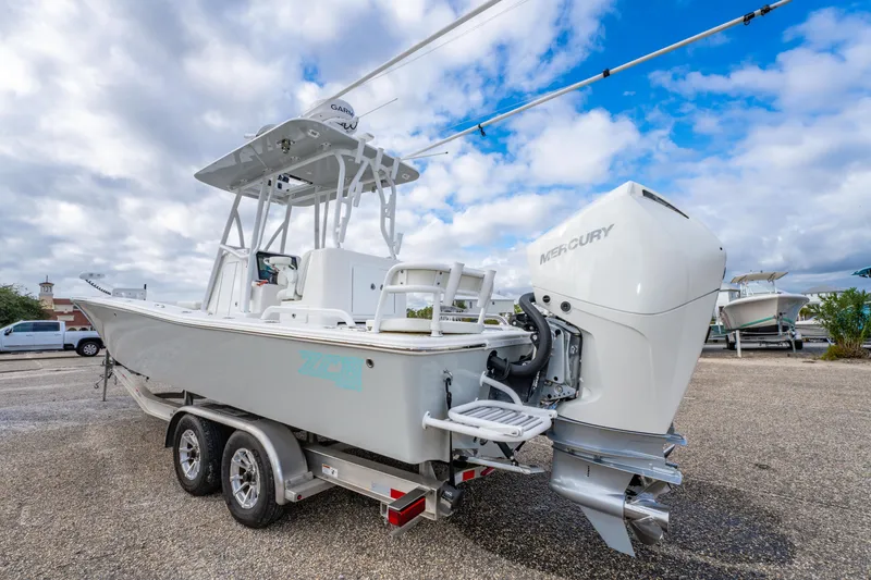 Slide: The Image of 2024 ZCB Freemason 26 Open boat with Mercury engine on trailer under cloudy sky. - 14