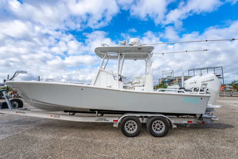 Slide: The Image of 2024 ZCB Freemason 26 Open boat on trailer under cloudy sky. - 15