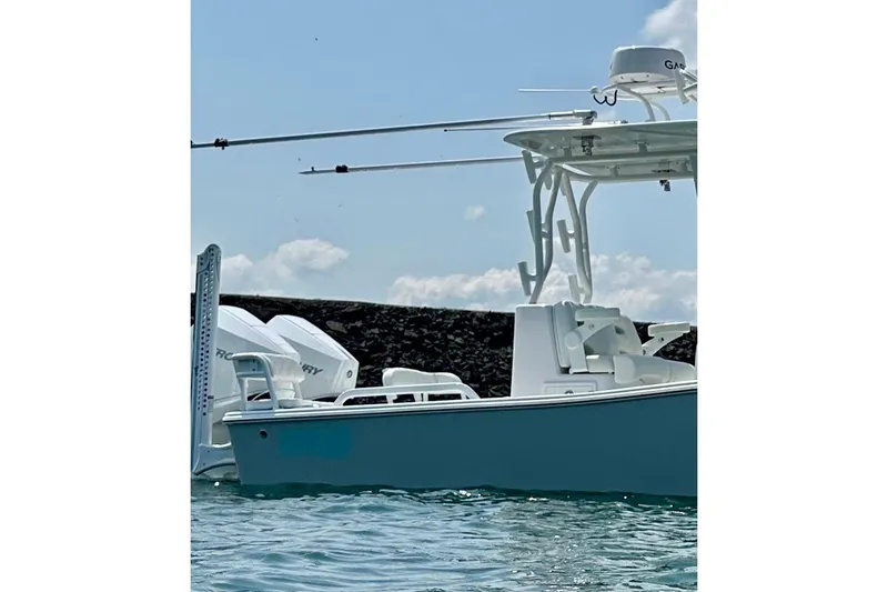 Slide: The Image of 2024 ZCB Freemason 26 Open boat on trailer, featuring dual Mercury engines. - 2