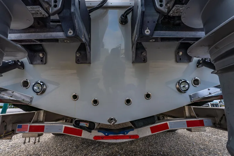 Slide: The Image of 2024 ZCB Freemason 26 Open boat stern with dual outboard motors and trailer. - 21