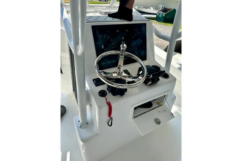 Slide: The Image of 2024 ZCB Freemason 26 Open boat on trailer, urban backdrop, cloudy sky. - 3