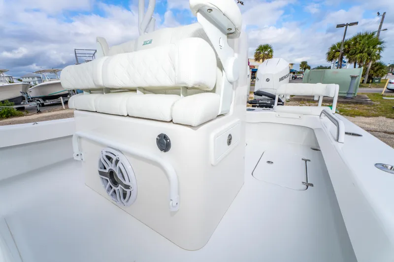Slide: The Image of 2024 ZCB Freemason 26 Open boat interior with white seating and speaker. - 30