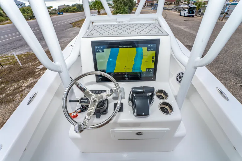 Slide: The Image of 2024 ZCB Freemason 26 Open boat dashboard with steering wheel and navigation display. - 33