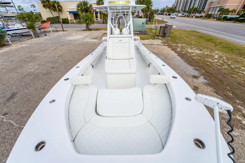Slide: The Image of 2024 ZCB Freemason 26 Open boat with white cushioned seating, parked near a road. - 40