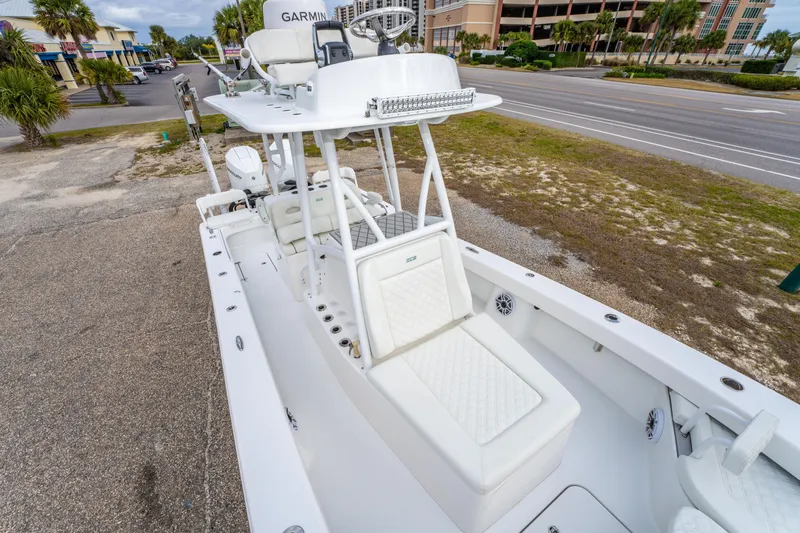 Slide: The Image of 2024 ZCB Freemason 26 Open boat with white seating and Garmin equipment, parked roadside. - 41