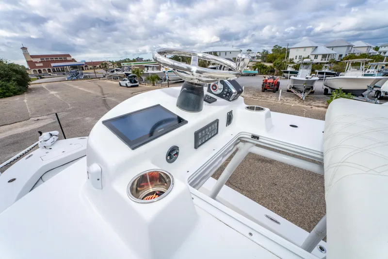 Slide: The Image of 2024 ZCB Freemason 26 Open boat dashboard with steering wheel and controls. - 45