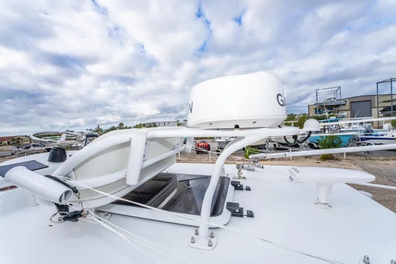 Slide: The Image of 2024 ZCB Freemason 26 Open boat with radar equipment, docked under cloudy skies. - 46