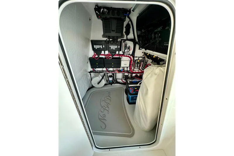Slide: The Image of Electrical compartment of 2024 ZCB Freemason 26 Open boat, showcasing wiring and equipment. - 48