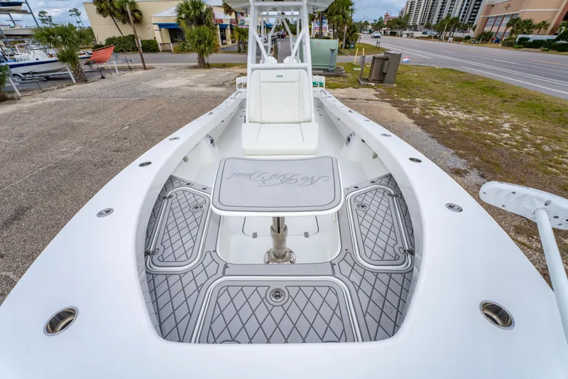 Slide: The Image of 2024 ZCB Freemason 26 Open boat with spacious deck and seating, parked near a road. - 50