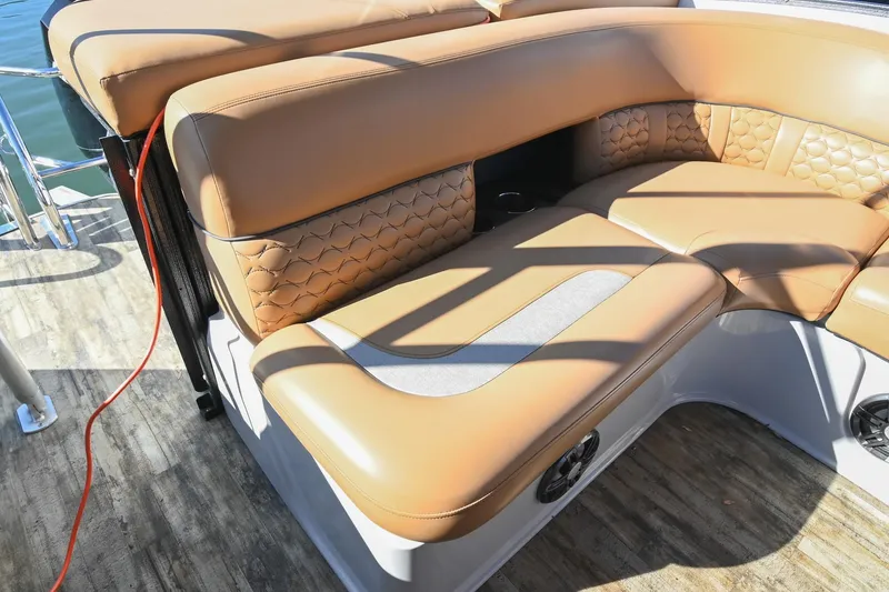 Slide: The Image of 2023 Crest Caribbean LX 250 boat with luxurious tan seating and stylish design. - 14