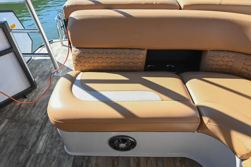 Slide: The Image of 2023 Crest Caribbean LX 250 boat interior with tan seating and wood flooring. - 15