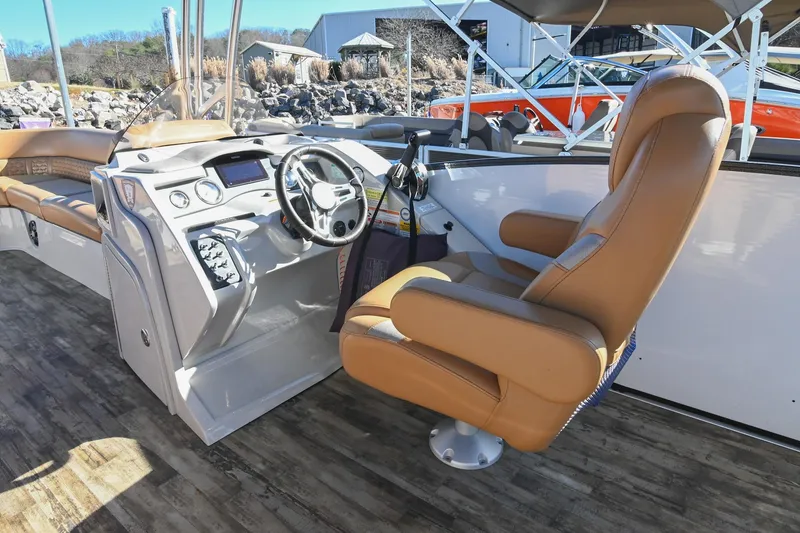 Slide: The Image of 2023 Crest Caribbean LX 250 boat interior with captain's chair and control panel. - 19
