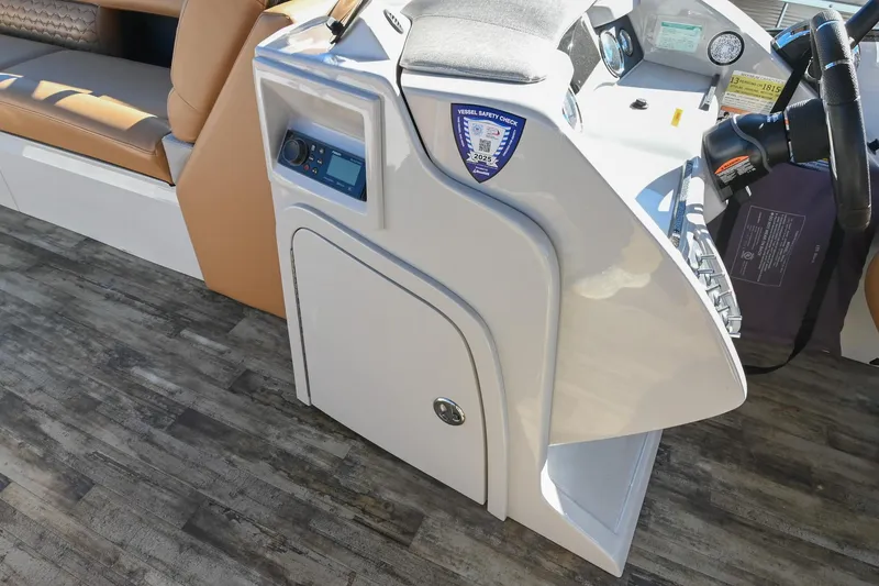 Slide: The Image of 2023 Crest Caribbean LX 250 boat console with safety check sticker and controls. - 22