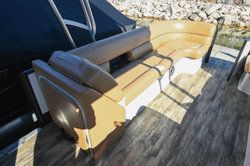 Slide: The Image of 2023 Crest Caribbean LX 250 boat interior with tan seating and wood-style flooring. - 24