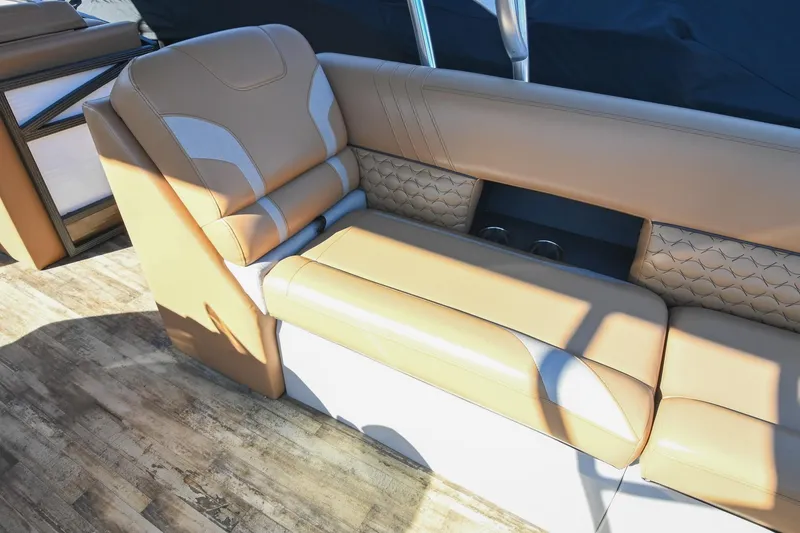 Slide: The Image of Luxurious seating on 2023 Crest Caribbean LX 250 boat with tan upholstery and cup holders. - 25