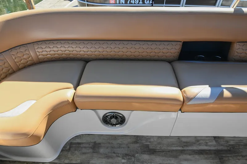 Slide: The Image of 2023 Crest Caribbean LX 250 boat interior with tan leather seating and speaker. - 29