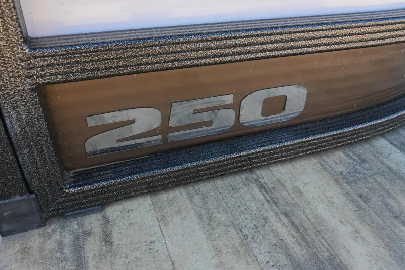Slide: The Image of 2023 Crest Caribbean LX 250 boat detail with "250" emblem. - 8