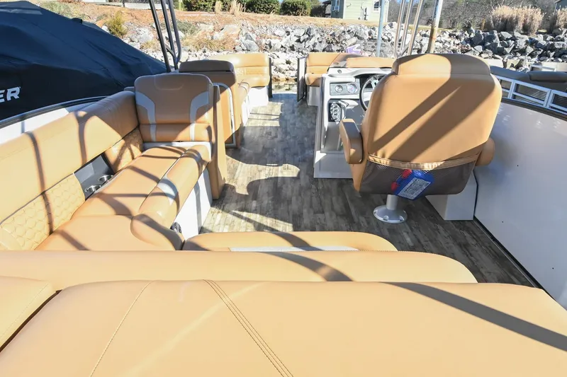 Slide: The Image of 2023 Crest Caribbean LX 250 boat interior with tan seating and modern design. - 9