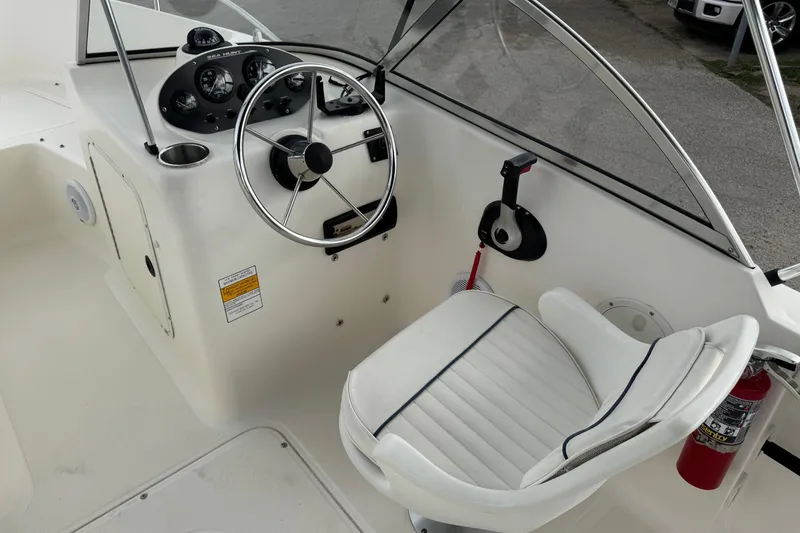 Slide: The Image of Interior of 2000 Sea Hunt Escape 200 boat showing steering wheel and captain's chair. - 10