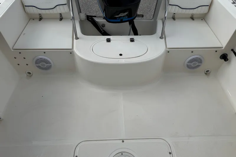 Slide: The Image of 2000 Sea Hunt Escape 200 boat interior with seating and motor, featuring clean white deck. - 18