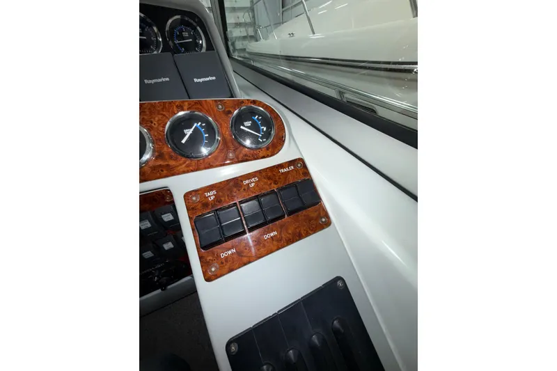 Slide: The Image of 2004 Formula 34 Performance Cruiser dashboard with Raymarine equipment and RPM gauges. - 27