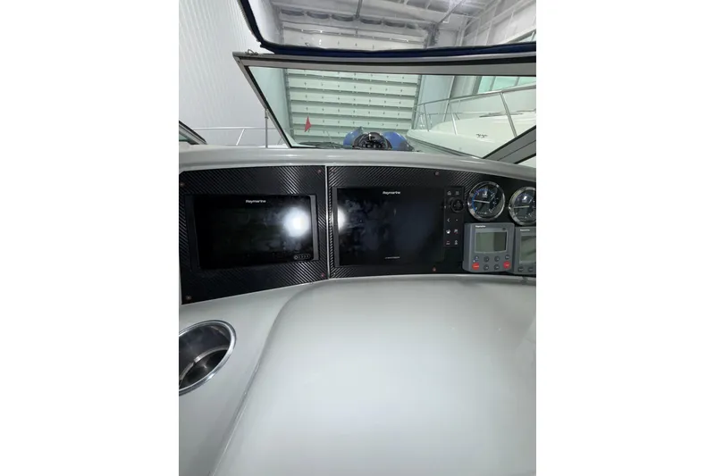 Slide: The Image of Control panel of a 2004 Formula 34 Performance Cruiser with radio and switches. - 28