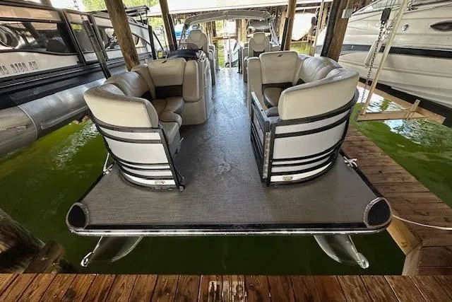 Slide: The Image of 2020 Starcraft SLS 3 pontoon boat docked, featuring spacious seating and sleek design. - 5