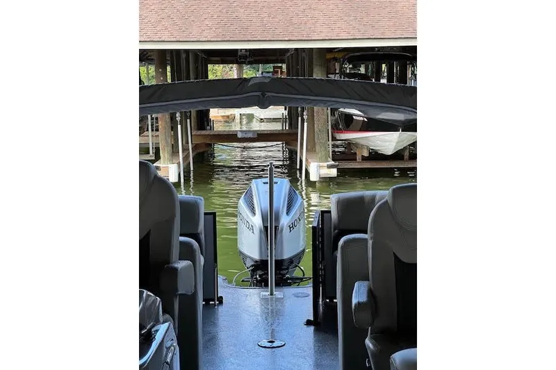 Slide: The Image of 2020 Starcraft SLS 3 boat with Honda outboard motor in a docked position. - 6