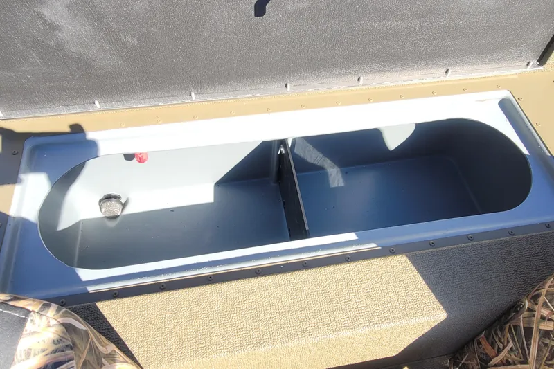 Slide: The Image of 2026 G3 Sportsman 1710 boat storage compartment, open and empty, with textured interior. - 16